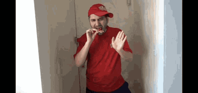 a man wearing a red shirt and a red hat that says ' ea ' on it