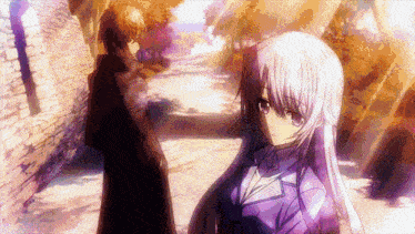 a man and a girl are standing next to each other on a path