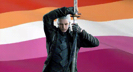 a man in a black suit is holding a sword in front of a lesbian flag .