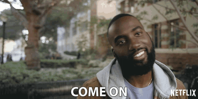 a man with a beard is smiling and says come on in a netflix ad