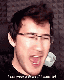 a man wearing glasses is saying i can wear a dress if i want to