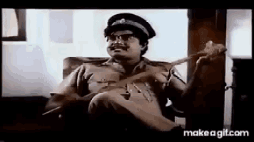 a police officer is sitting in a chair playing a guitar .