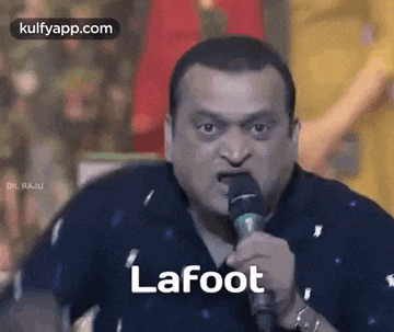 a man is singing into a microphone with the word lafoot written on it .