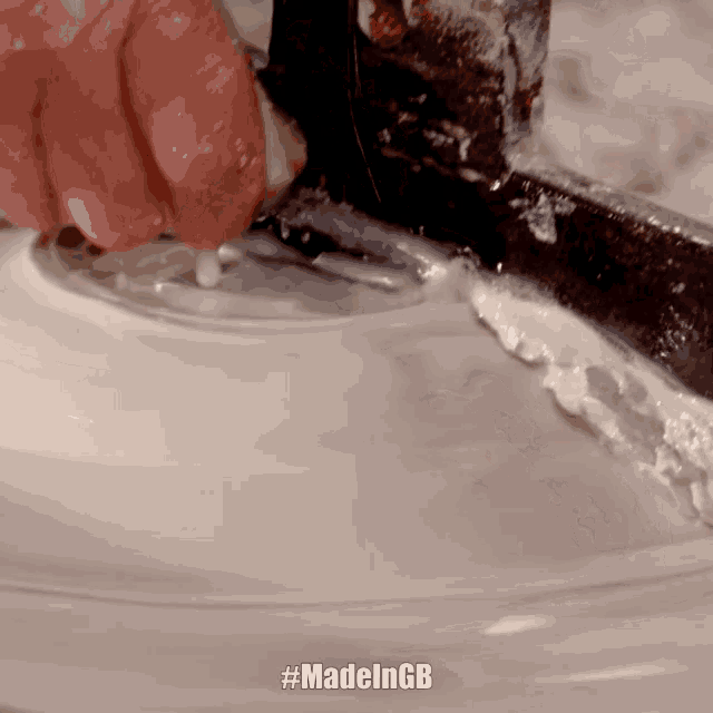 a close up of a person using a spatula with #madelngb written on the bottom