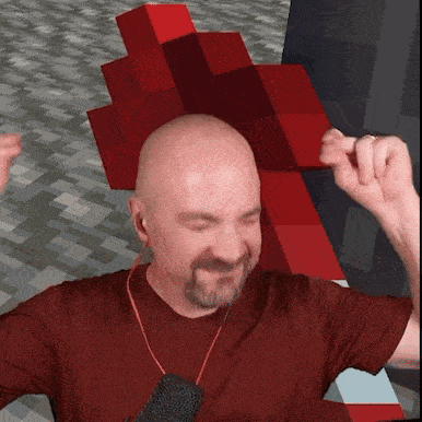 a bald man with a beard is wearing a red shirt and a microphone