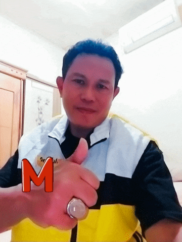 a man giving a thumbs up with the letter m on his arm