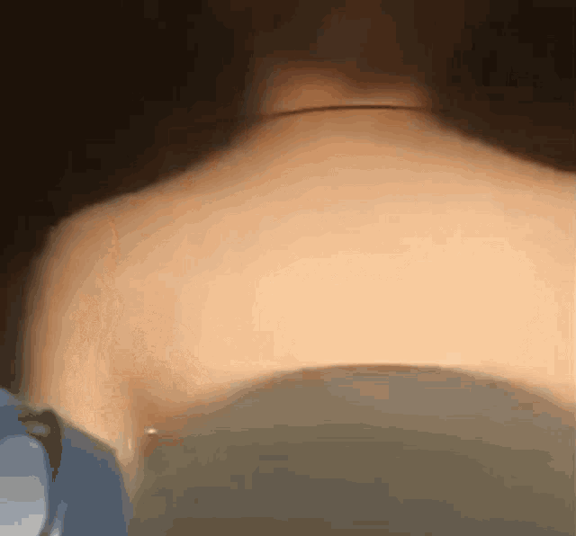 a close up of a person 's back with a necklace on it .