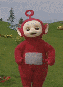a red teletubbies character standing in a field