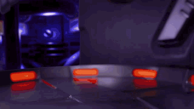 a blurred image of a person 's torso with red lights in the background