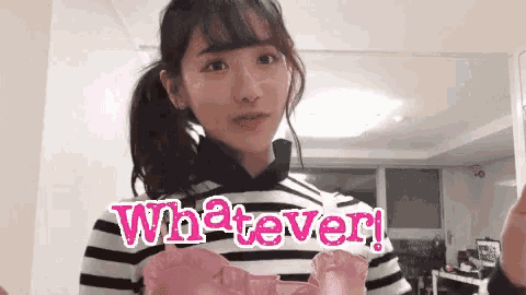 a girl in a striped shirt is holding a pink heart shaped balloon that says whatever