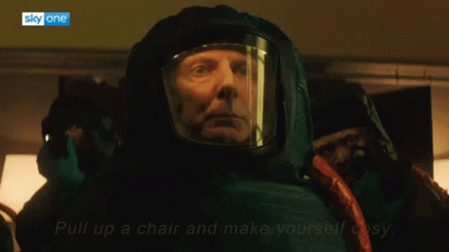 Pull Up A Chair And M Ake Youself Cosy Mask GIF - Pull Up A Chair And M Ake Youself Cosy Mask Talking GIFs