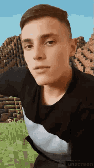 a man in a black shirt is standing in front of a minecraft background .