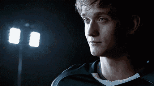 a close up of a man 's face in front of two lights
