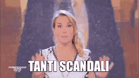 a woman is standing in front of a screen with the words tanti scandali written on it .