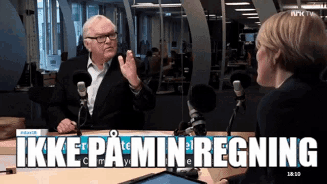 a man in a suit is talking to a woman in front of microphones and the words ikke pa min regning are displayed