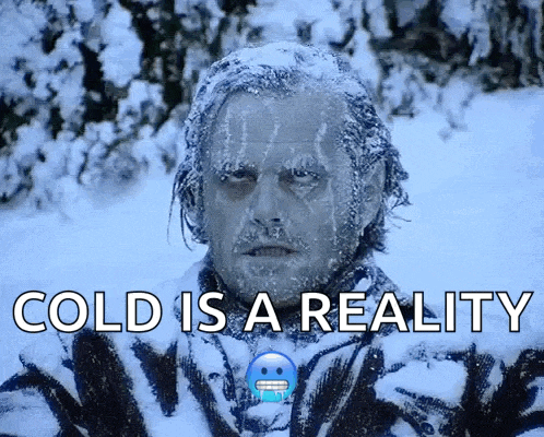 a picture of a man covered in snow with the words cold is a reality below him