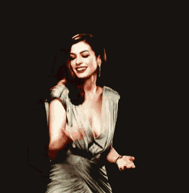 a woman in a plunging neckline dress is dancing on a black background