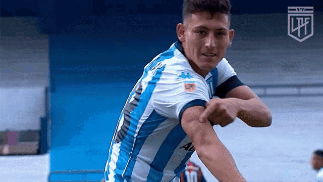 a soccer player wearing a blue and white jersey with the number 11 on the back