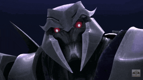 a close up of a robot with red eyes and the word transformers on the bottom