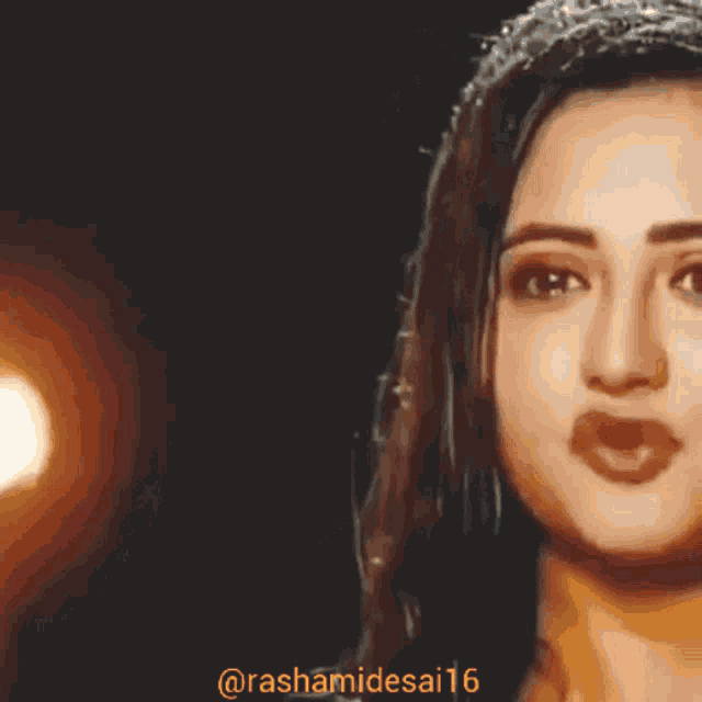 a close up of a woman 's face with the hashtag rashamidesai16 on the bottom