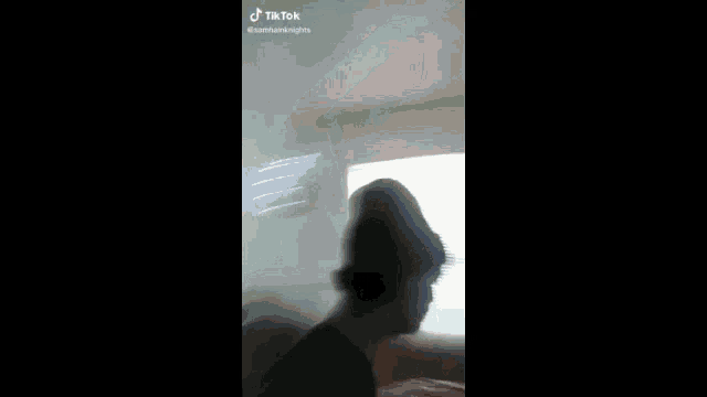 a blurry picture of a man with a beard and a hat .