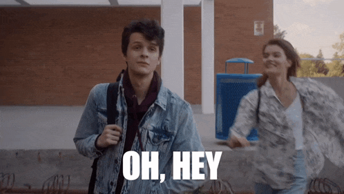 a man in a denim jacket says " oh hey " while walking