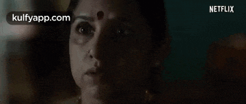 a close up of a woman 's face in a dark room with a netflix logo in the corner .