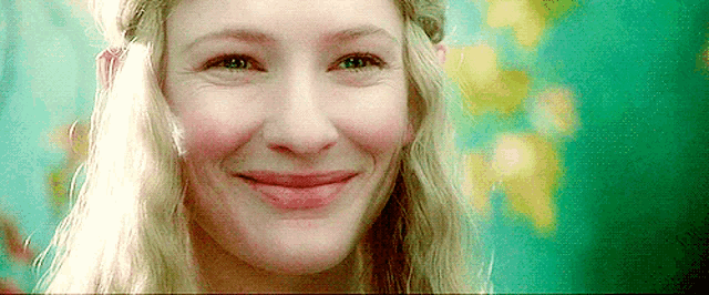 a close up of a woman 's face with a smile on it .