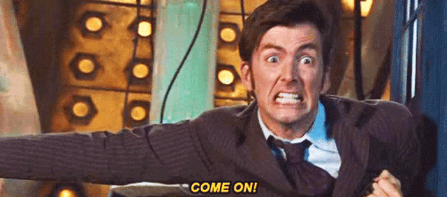 a man in a suit and tie is making a funny face and saying `` come on ! ''