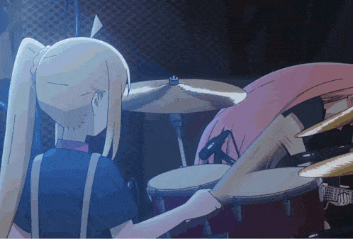 a girl with blonde hair is playing drums in a dark room
