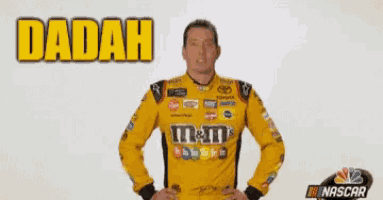 a man wearing a yellow m & m 's shirt is dancing