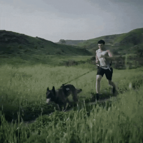 a man running with a dog on a leash