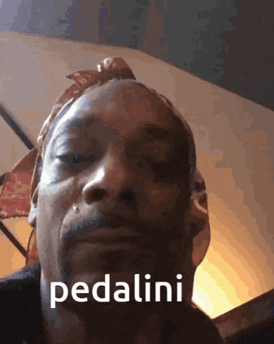 a close up of a man 's face with the word pedalini written on it