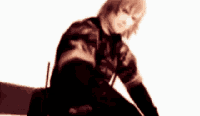 a blurred image of a person sitting on a chair with a white background .
