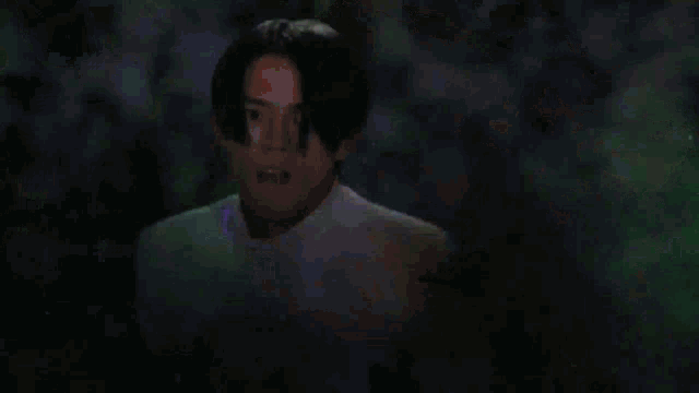 a person is standing in the dark with a glowing object in the background