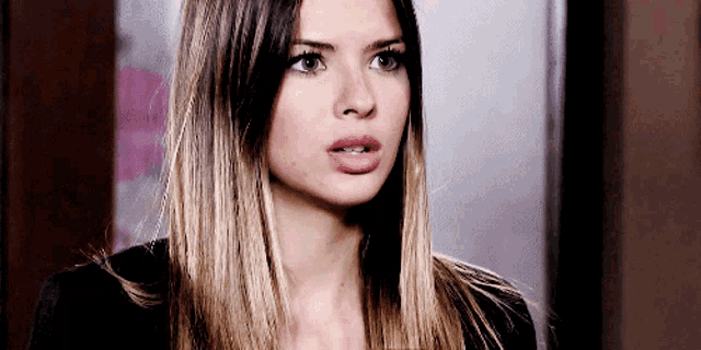 a close up of a woman 's face with a surprised expression