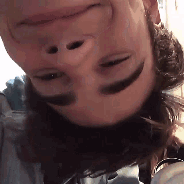 a close up of a person 's face with a smile on it