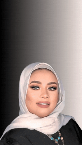 a woman wearing a white scarf and a black top