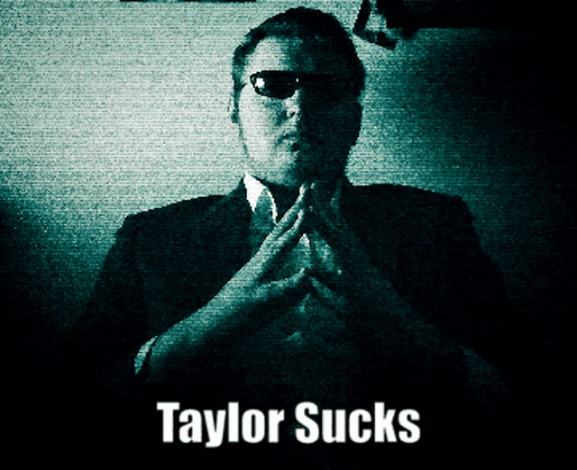 a black and white photo of a man with the words taylor sucks on the bottom
