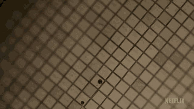 blood stains on a tiled floor with netflix written on the bottom