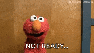 elmo from sesame street is standing in front of a wooden wall and says `` not ready '' .