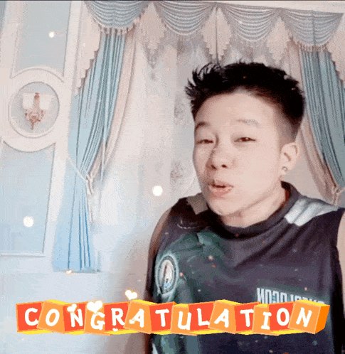 a boy in a tank top stands in front of a sign that says congratulations