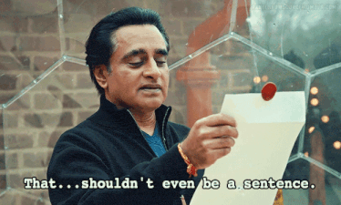 a man holding a piece of paper with the words that shouldn 't even be a sentence below him