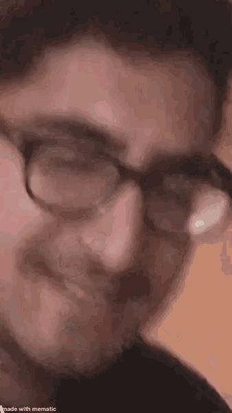 a close up of a person wearing glasses making a funny face .