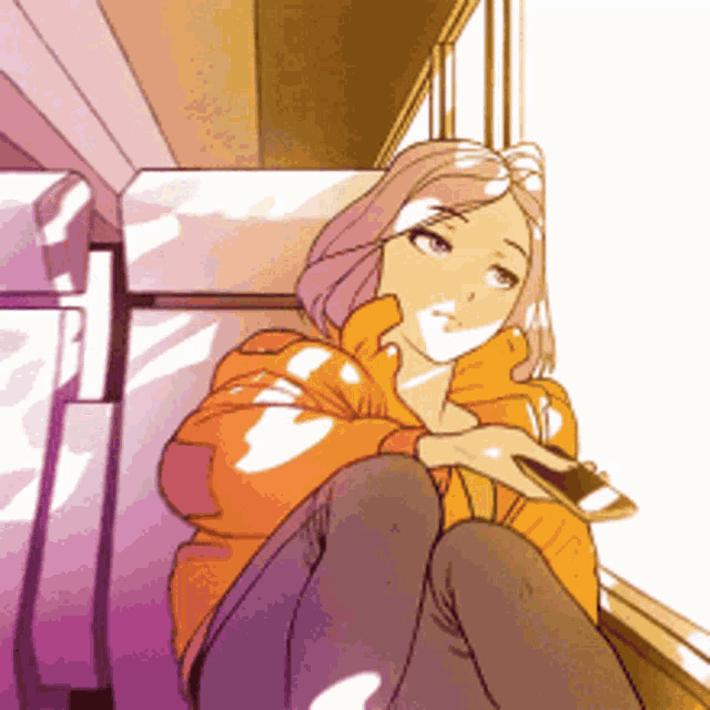 a girl is sitting on a couch with a cell phone in her hand