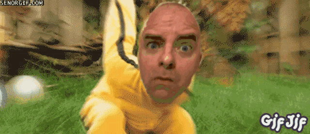 a gif of a bald man in a yellow suit with the words gif jif below him