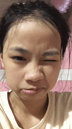 a close up of a girl 's face with a pink background