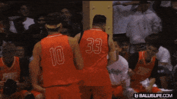 a basketball player wearing a red jersey with the number 33 on it