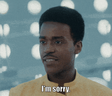 a man says i 'm sorry in front of a blurry background