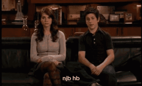 a man and a woman are sitting on a couch and njb hb is written in the corner